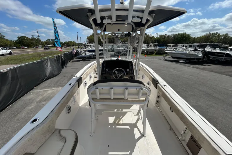 Slide: The Image of 2019 Robalo R242 Explorer boat interior with helm, parked at dealership. - 15