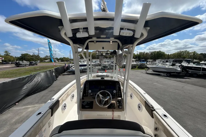 Slide: The Image of 2019 Robalo R242 Explorer boat interior with steering console and overhead canopy. - 17