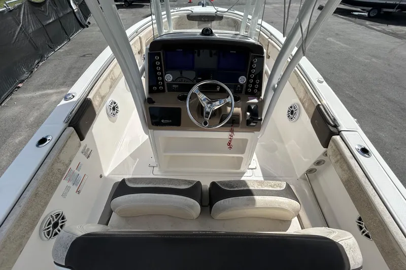 Slide: The Image of 2019 Robalo R242 Explorer boat cockpit with steering wheel and control panel. - 18