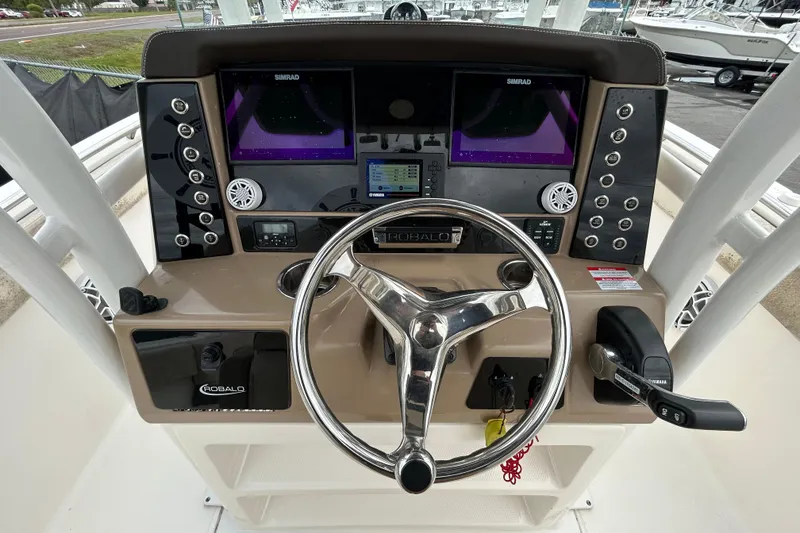 Slide: The Image of 2019 Robalo R242 Explorer helm with dual Simrad displays and Yamaha controls. - 19