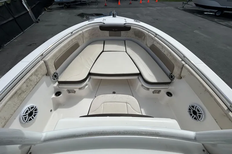 Slide: The Image of 2019 Robalo R242 Explorer boat interior with cushioned seating and speakers. - 22
