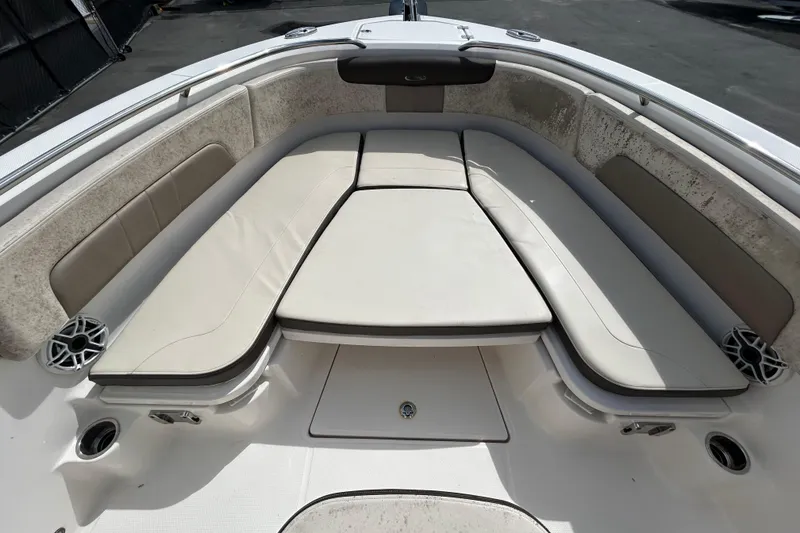 Slide: The Image of 2019 Robalo R242 Explorer boat interior with cushioned seating and speakers. - 23