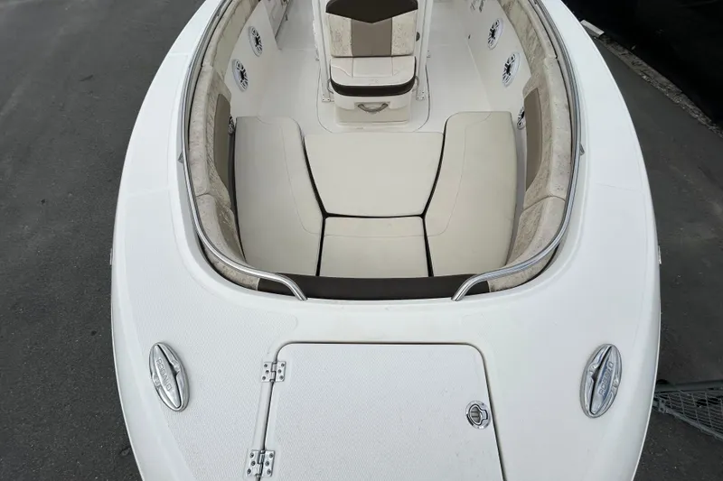 Slide: The Image of 2019 Robalo R242 Explorer boat interior with cushioned seating and storage compartments. - 25