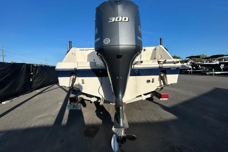 Slide: The Image of 2019 Robalo R242 Explorer boat with 300 HP engine, parked outdoors. - 3