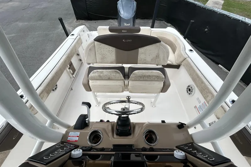 Slide: The Image of 2019 Robalo R242 Explorer boat interior with helm and seating area. - 32