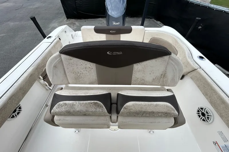 Slide: The Image of 2019 Robalo R242 Explorer boat seating with weathered upholstery and visible speakers. - 33