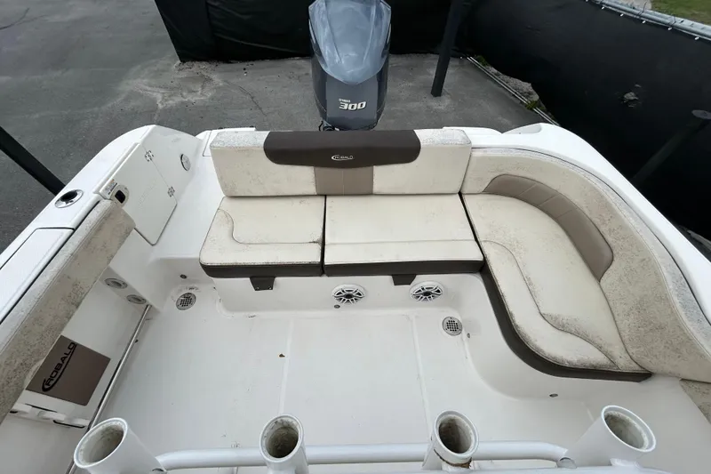 Slide: The Image of 2019 Robalo R242 Explorer boat interior with cushioned seating and rod holders. - 34