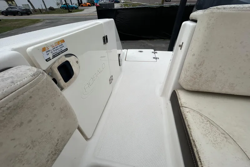 Slide: The Image of 2019 Robalo R242 Explorer boat interior with seating and storage compartment. - 35