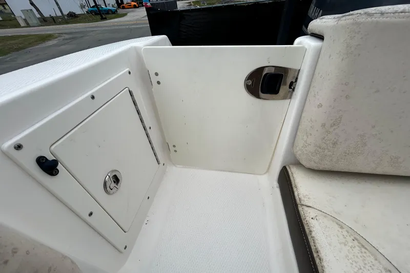 Slide: The Image of 2019 Robalo R242 Explorer boat interior with storage compartment and seating area. - 36