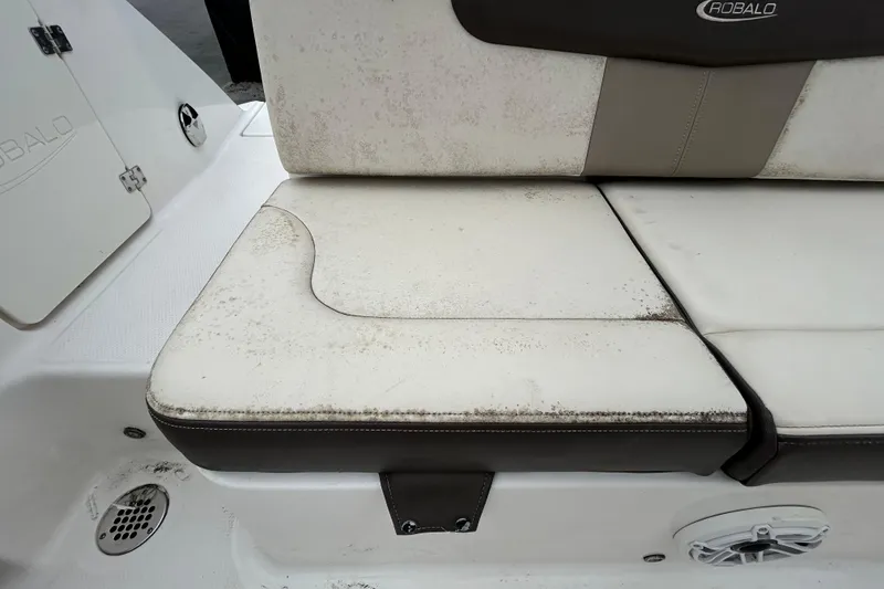 Slide: The Image of 2019 Robalo R242 Explorer boat seat with visible wear and stains. - 40