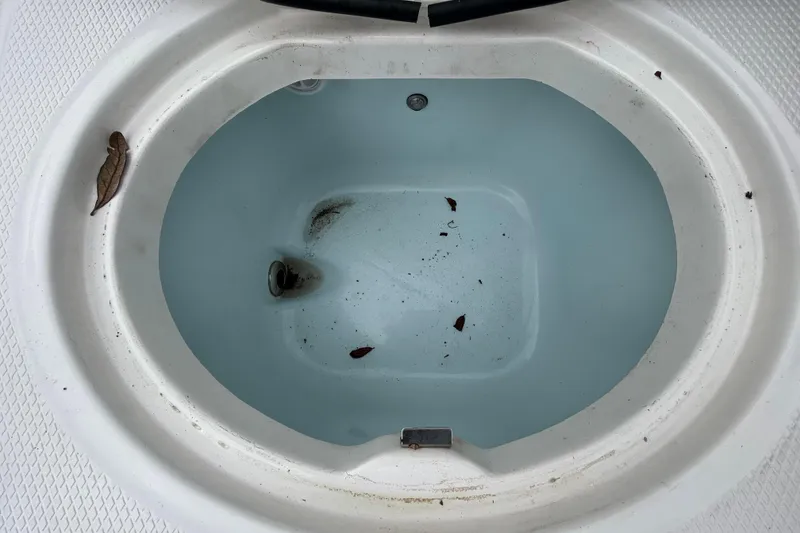 Slide: The Image of Livewell on 2019 Robalo R242 Explorer boat with leaves and debris inside. - 43