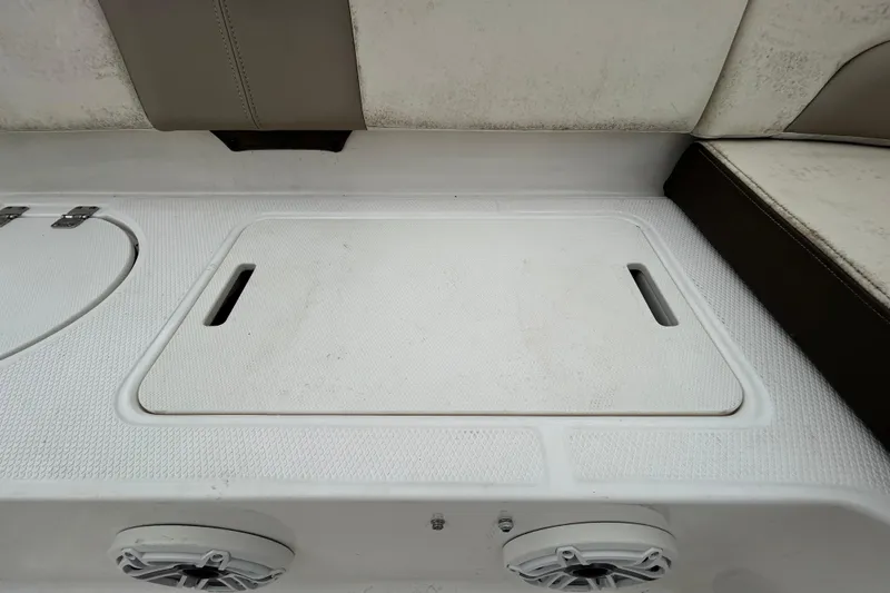 Slide: The Image of 2019 Robalo R242 Explorer boat seating and storage area with speakers. - 45