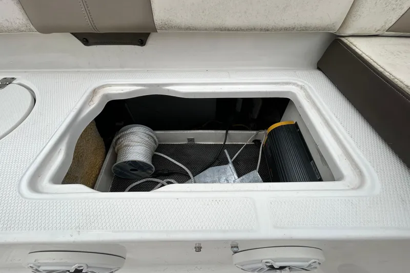 Slide: The Image of Storage compartment on a 2019 Robalo R242 Explorer boat with rope and equipment. - 46