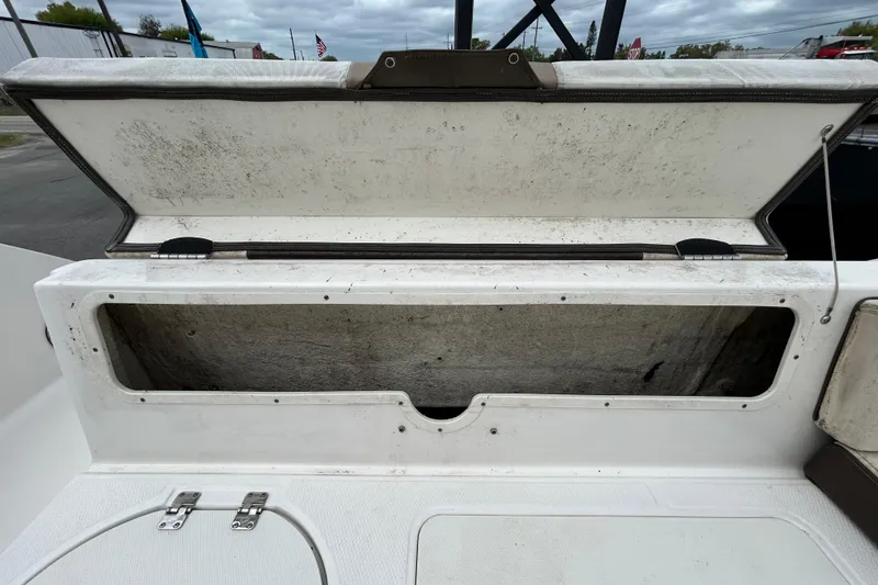 Slide: The Image of Open storage compartment on a 2019 Robalo R242 Explorer boat, showing interior space. - 49
