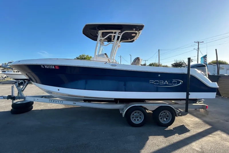 Slide: The Image of 2019 Robalo R242 Explorer boat rear view with propeller and ladder. - 5