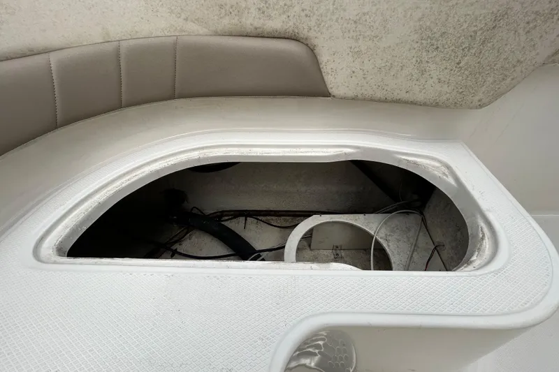 Slide: The Image of 2019 Robalo R242 Explorer boat storage compartment with open hatch, showcasing interior details. - 54