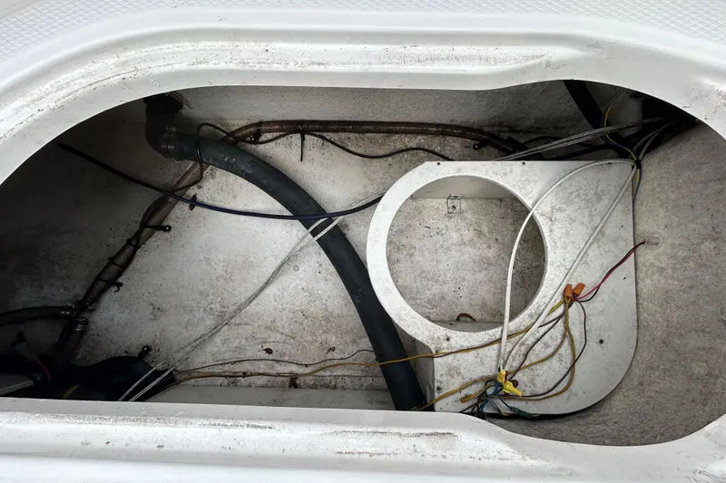 Slide: The Image of 2019 Robalo R242 Explorer boat compartment with wiring and tubing. - 55