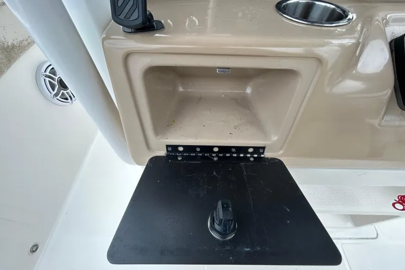 Slide: The Image of 2019 Robalo R242 Explorer boat interior with storage compartment and cup holder. - 59