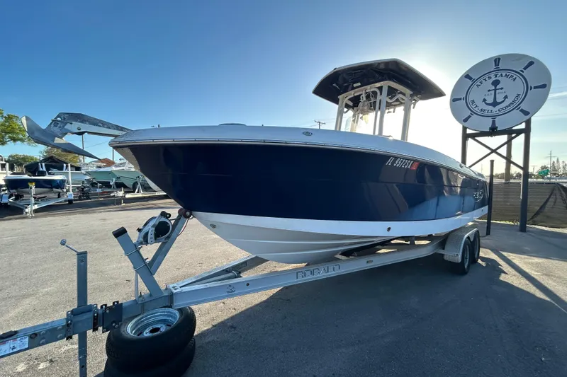 Slide: The Image of 2019 Robalo R242 Explorer boat with Yamaha engine on trailer under blue sky. - 6