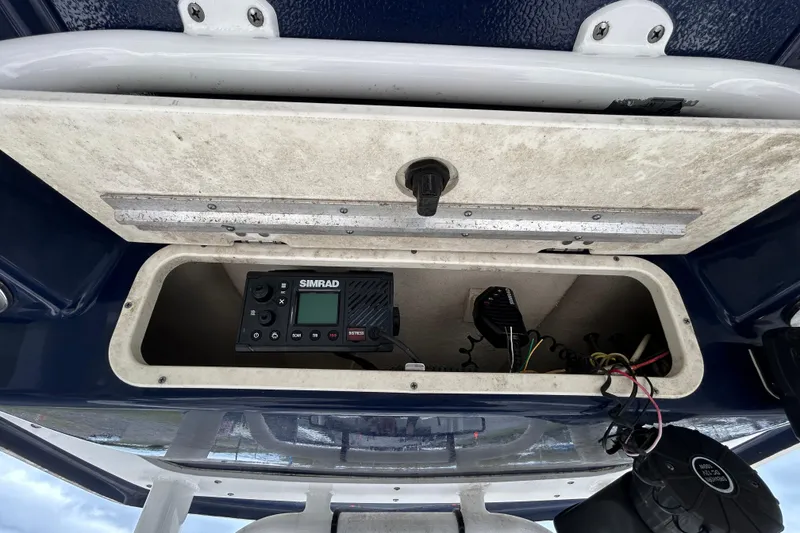 Slide: The Image of 2019 Robalo R242 Explorer storage compartment with Simrad marine electronics. - 62