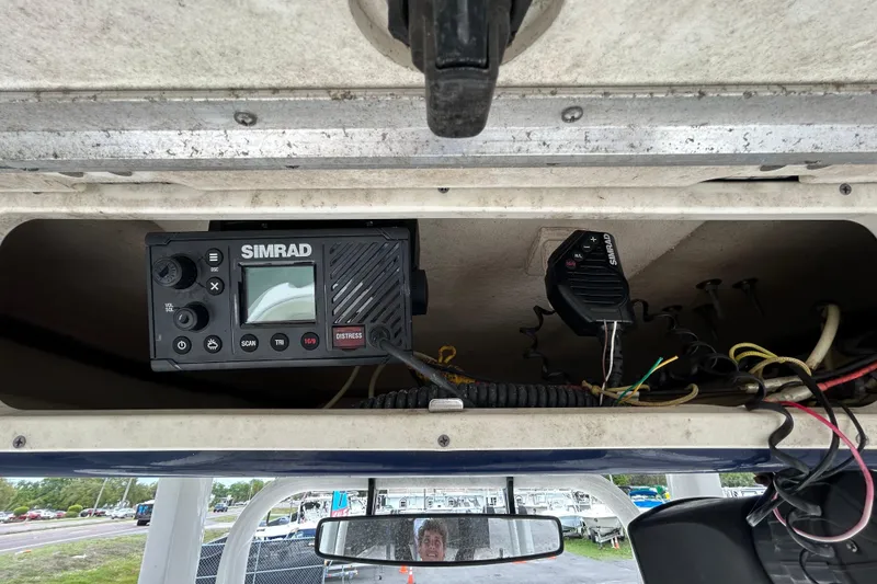 Slide: The Image of Simrad marine radio installed on a 2019 Robalo R242 Explorer boat dashboard. - 63
