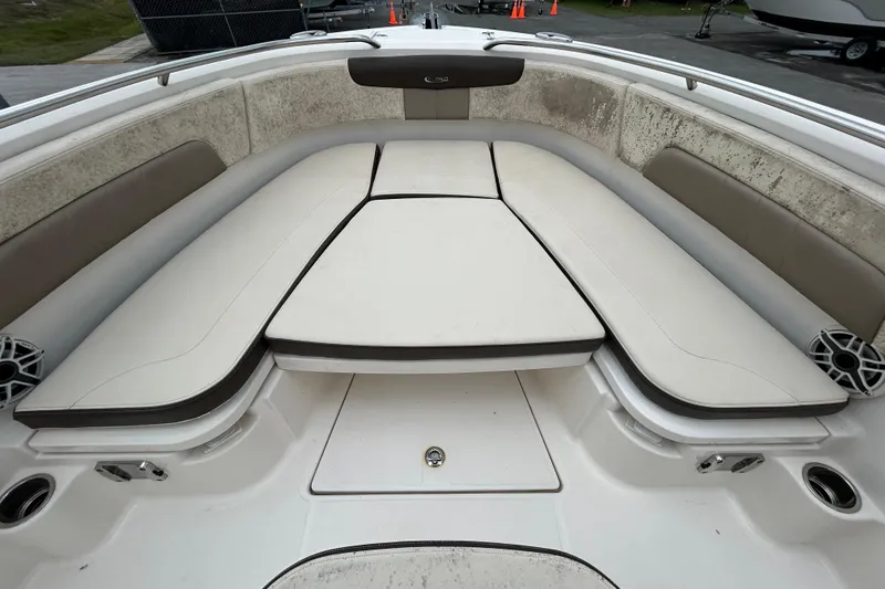 Slide: The Image of 2019 Robalo R242 Explorer boat interior with cushioned seating and storage compartments. - 64