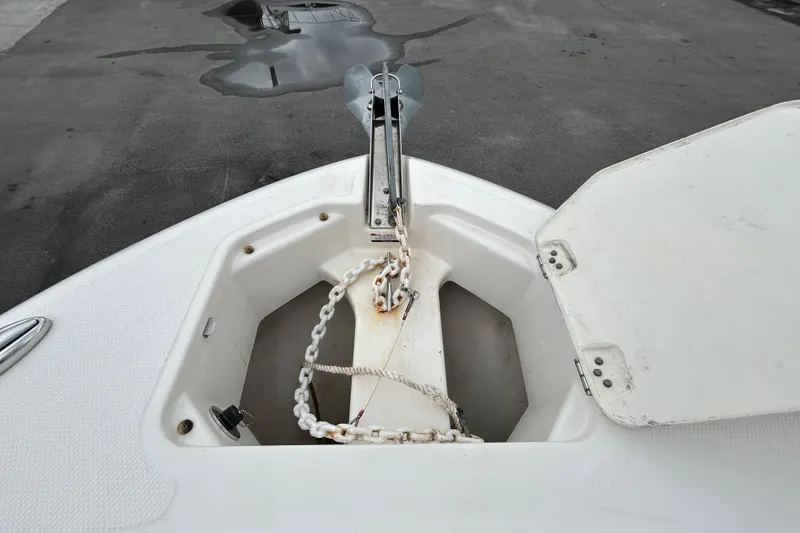 Slide: The Image of 2019 Robalo R242 Explorer anchor compartment with chain and open hatch. - 74