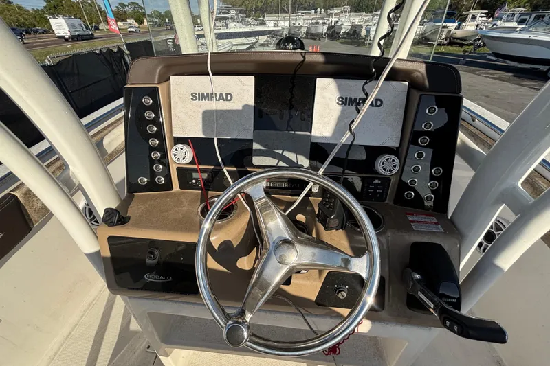 Slide: The Image of 2019 Robalo R242 Explorer boat on trailer under clear blue sky. - 8