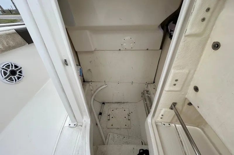 Slide: The Image of 2019 Robalo R242 Explorer boat interior, featuring storage compartment and speaker. - 84