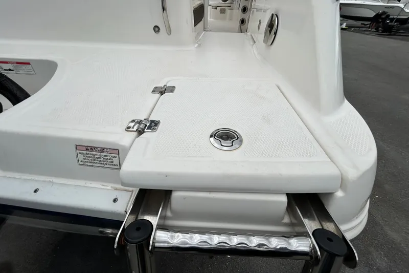 Slide: The Image of 2019 Robalo R242 Explorer boat swim platform with ladder and hatch. - 86