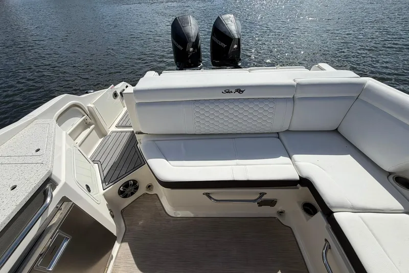 Slide: The Image of 2020 Sea Ray SDX 290 Outboard boat with white seating and dual engines on water. - 10
