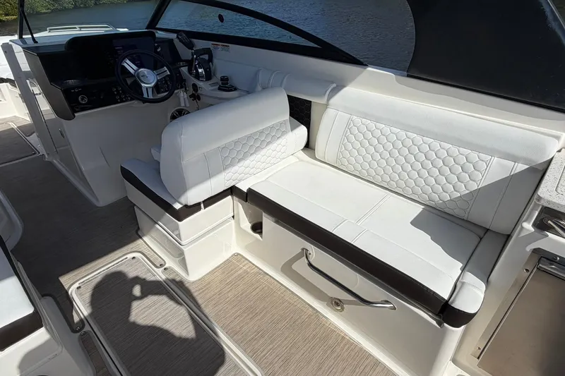 Slide: The Image of 2020 Sea Ray SDX 290 Outboard interior with white seating and steering console. - 12