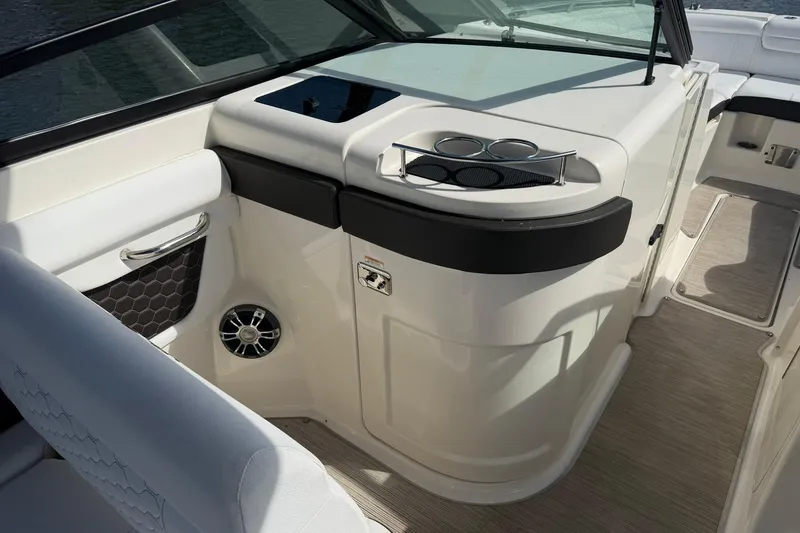 Slide: The Image of 2020 Sea Ray SDX 290 Outboard interior with cup holders and speaker. - 17