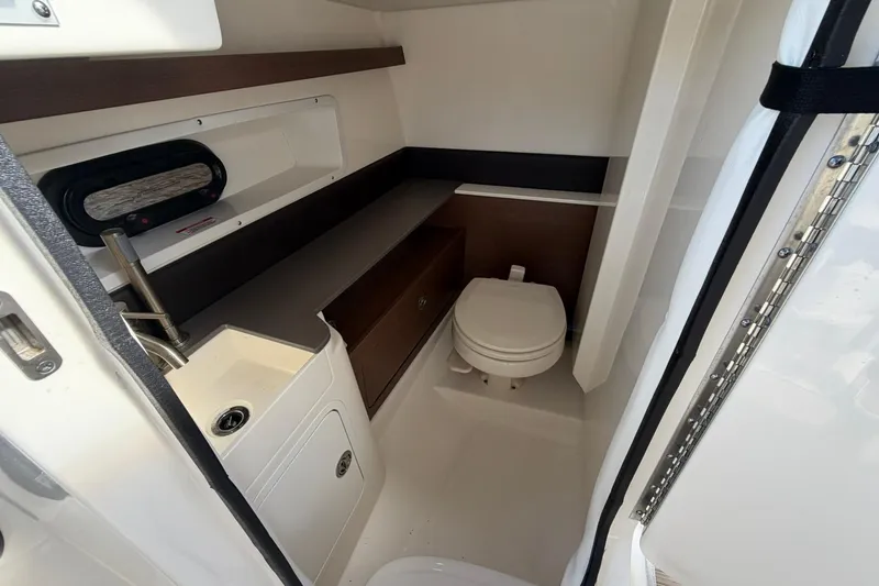 Slide: The Image of 2020 Sea Ray SDX 290 Outboard boat interior with compact bathroom amenities. - 18