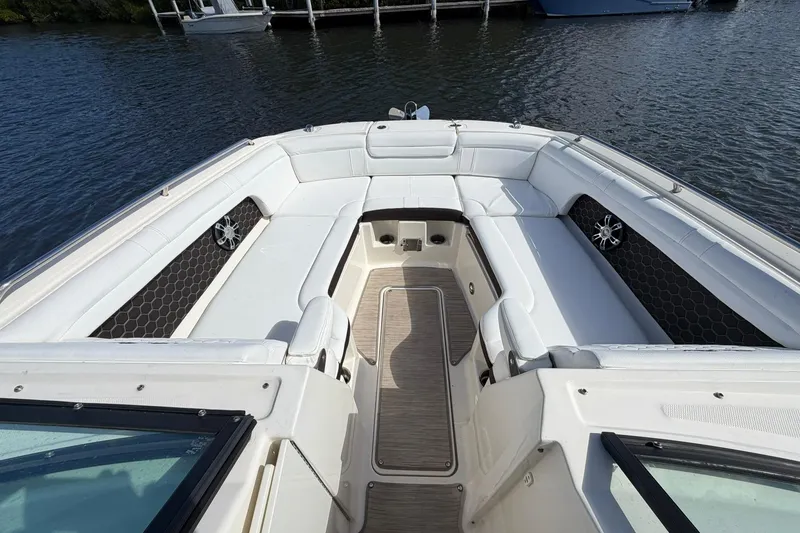 Slide: The Image of 2020 Sea Ray SDX 290 Outboard boat interior with white seating and water view. - 20