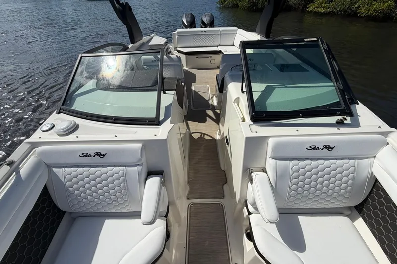 Slide: The Image of 2020 Sea Ray SDX 290 Outboard boat interior with white seating and dual consoles. - 21
