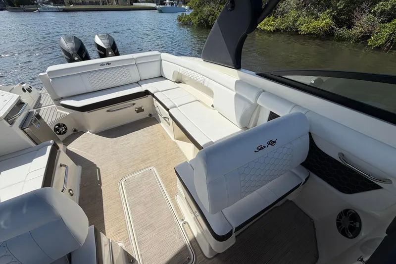 Slide: The Image of 2020 Sea Ray SDX 290 Outboard boat interior with white seating and water view. - 25