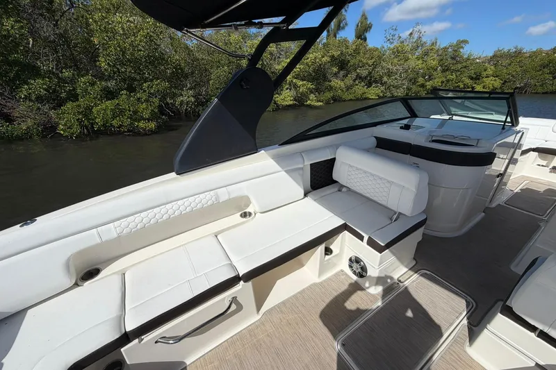 Slide: The Image of 2020 Sea Ray SDX 290 Outboard boat interior with white seating and sleek design. - 27