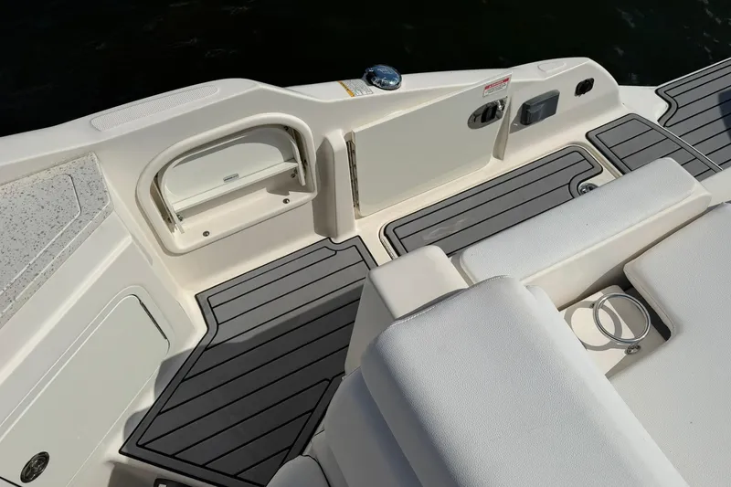 Slide: The Image of 2020 Sea Ray SDX 290 Outboard boat deck with seating and storage compartments. - 8