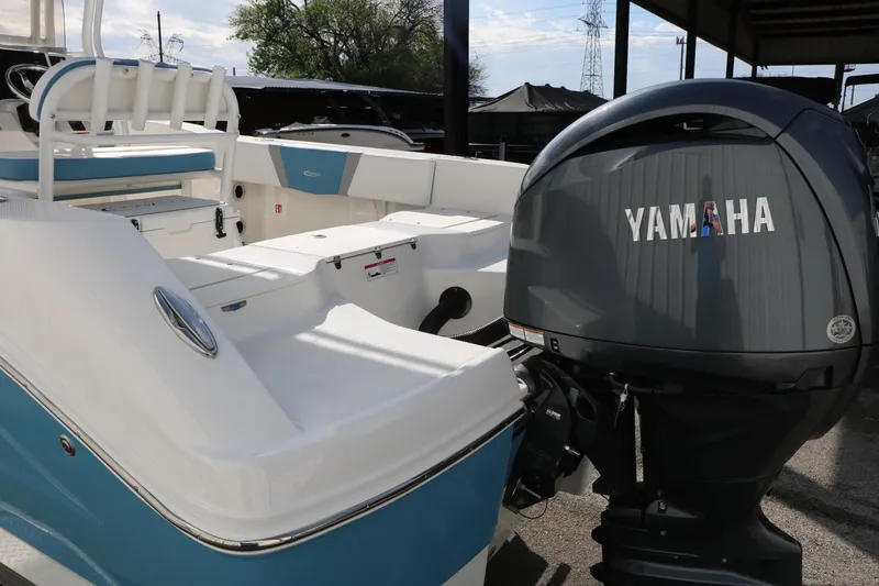Slide: The Image of 2026 Robalo R200 Center Console boat with Yamaha outboard motor, docked outdoors. - 12