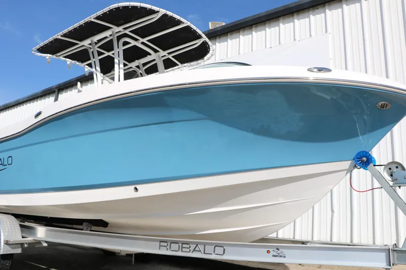 Slide: The Image of 2026 Robalo R200 Center Console boat on trailer, blue hull, white trim, outdoor display. - 14