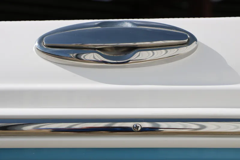 Slide: The Image of Close-up of a 2026 Robalo R200 Center Console boat's sleek chrome handle. - 16