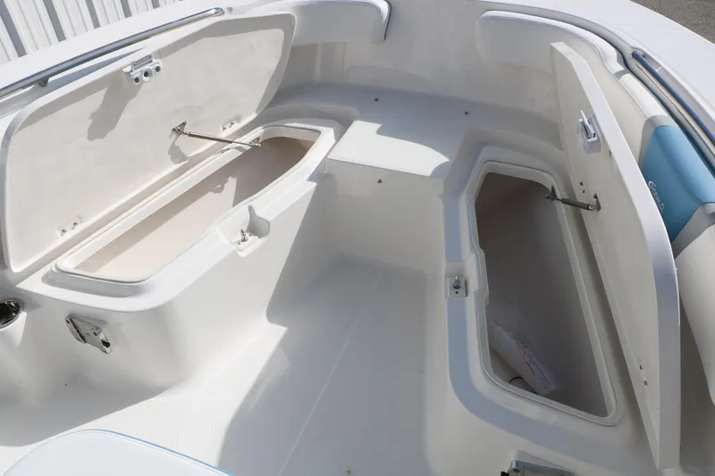 Slide: The Image of 2026 Robalo R200 Center Console boat storage compartments open, showcasing spacious interior design. - 33