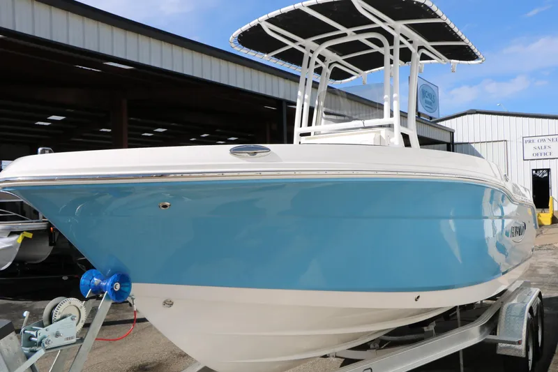 Slide: The Image of 2026 Robalo R200 Center Console boat with blue hull on trailer, outdoor display. - 5