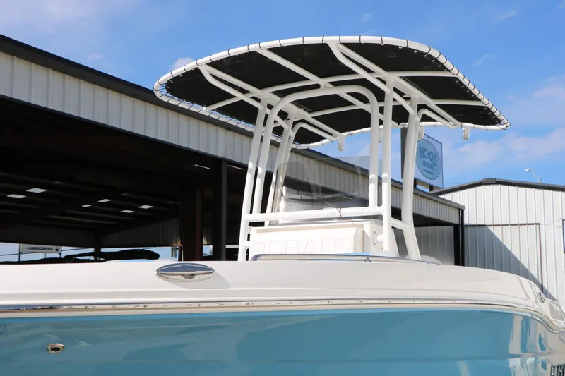 Slide: The Image of 2026 Robalo R200 Center Console boat with T-top, docked at marina. - 6