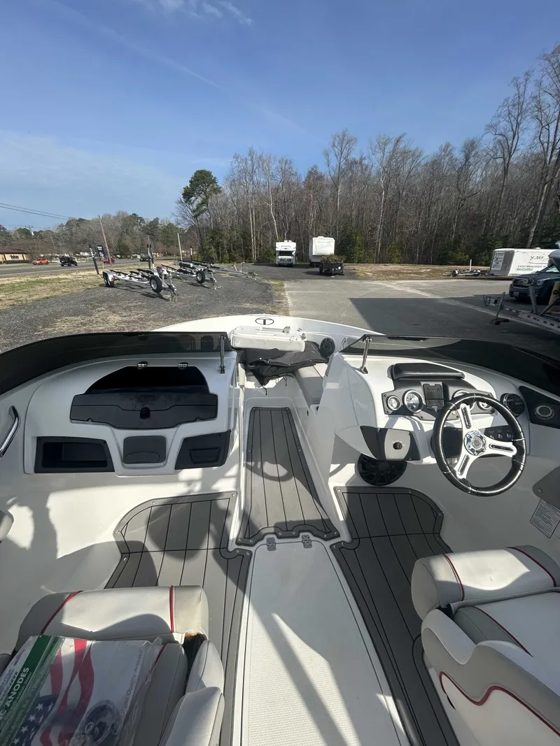 Slide: The Image of Interior of a 2019 Tahoe 700 Limited boat, featuring helm and seating. - 6