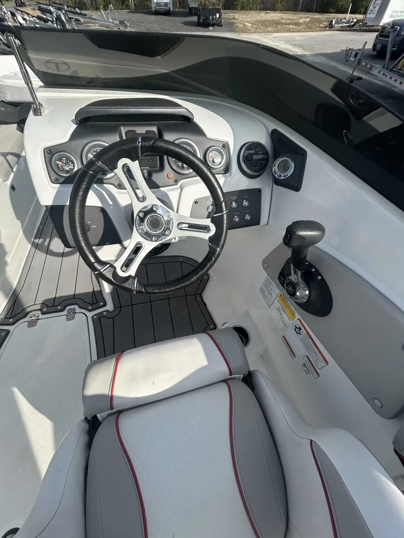 Slide: The Image of Interior of a 2019 Tahoe 700 Limited boat with steering console. - 8