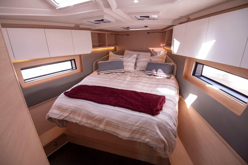 Slide: The Image of Luxurious cabin interior of 2024 Dufour 41 yacht with cozy bed and modern design. - 14