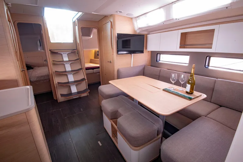 Slide: The Image of Luxurious interior of 2024 Dufour 41 yacht with modern dining area and cozy seating. - 15