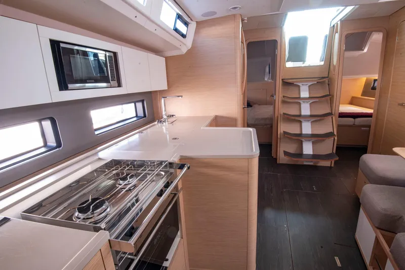 Slide: The Image of Modern interior of 2024 Dufour 41 yacht, featuring sleek kitchen and cozy living space. - 16